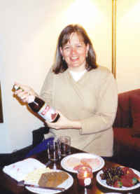 Kristin opens the bottle of bubbly!  Toronto, Canada, 2002.