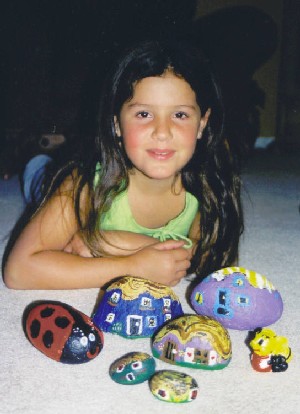 Maite with her painted rocks.
