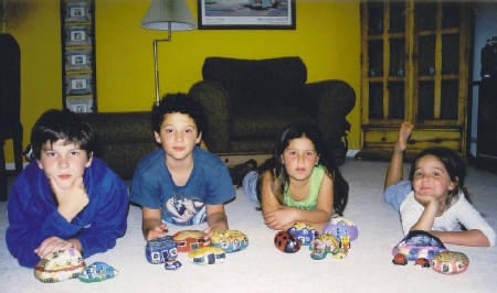 The whole family with their painted rocks.