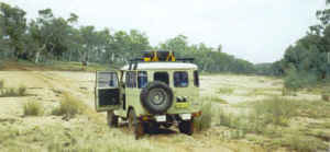 Lionel crossing a dry river bed.