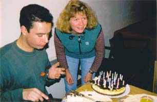 Birthday-boy and Anne cutting the cakes.