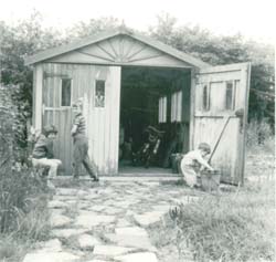 Rob at age 3 doing some DIY on the garage - with some help from Martin and Liz!