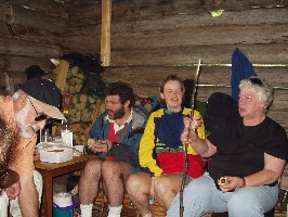 Rich, Rob, Hild and Viv grilling sausages on the bonfire at Voglumtveit.