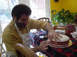 Rob putting the ribbon on the cake.