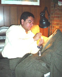 Alvaro sewing in a button.